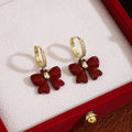 Red Bow Crystal Look Gold Tone Huggie Dangle Earrings view 1