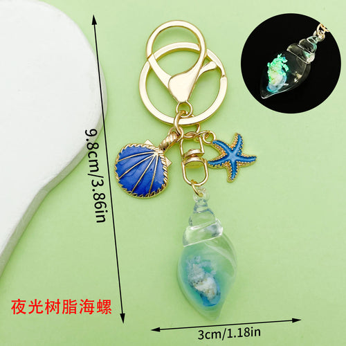 Dimension graphic showing starfish, conch and shell keychains with printed 9.8cm/3.86in measurements.