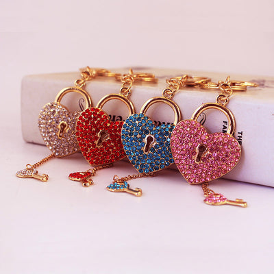 Four rhinestone heart locks in clear, red, blue, and pink are displayed with matching key charms.