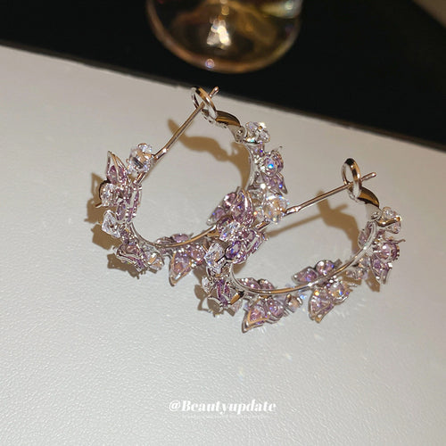 purple butterfly crystal cluster small hoop earrings displayed from a second angle