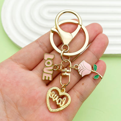 Image 1 showing a person holding up some gold charms.