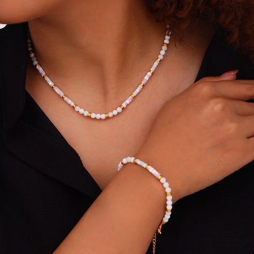 Model wearing white pink shell bead necklace and matching bracelet