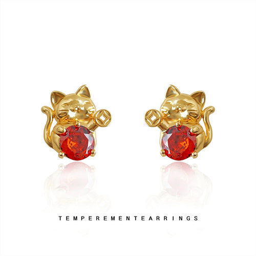 Gold lucky cat red stone studs on white reflective ground