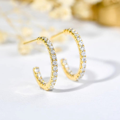Front product view of gold tone open hoop earrings with rows of clear stones