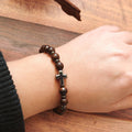 Dark Wood Bead Cross Stretch Bracelet with Silver Tone Spacers view 2