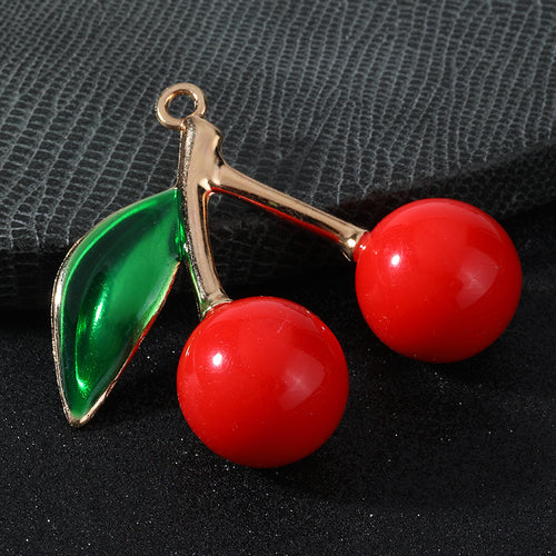 Single glossy red cherry charm with green enamel leaf