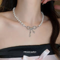 White Pearl Strand Necklace with Silver Tone Bow Center view 3