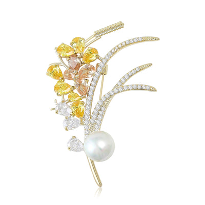 Front view of crystal flower spray brooch with curved stems and white pearl against a white background.