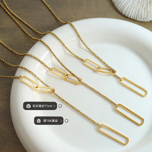 Three gold lariat necklaces on white dish showing oval links with length labels