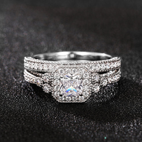 Silver-tone square halo three-ring set on black