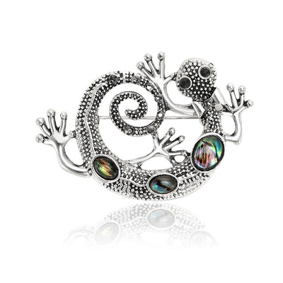 Front product view of the silver tone curled lizard brooch on a light background