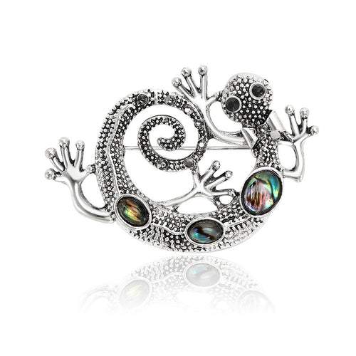 Front product view of the silver tone curled lizard brooch on a light background