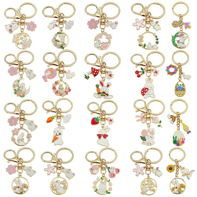 Catalog view of the pictured rabbit flower and carrot metal keychain on a light background