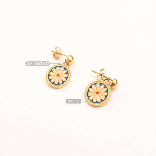 Pair of gold daisy enamel drops with titanium steel label
