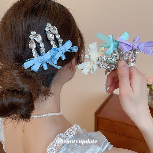 pink crystal bow clip with clear teardrop fringe worn at the side of the hair