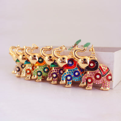 A row of gold-tone elephant charms decorated in assorted rhinestone colors.