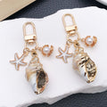 Four Gold Tone Shell Starfish and Pearl-Look Clasp Charms for Accessory Making view 1