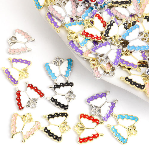 Assorted enamel butterfly charms arranged on a white background