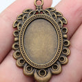 Antique Bronze Oval Cabochon Setting with Ornate Frame view 1
