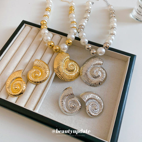 Gold and silver pearl seashell necklaces and shell studs in jewelry tray