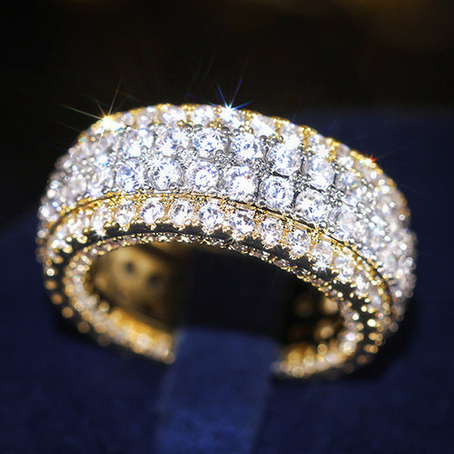 Close side view of two-tone pave eternity ring showing open multi-row stone face