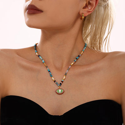 Multicolor stone bead necklace with green evil eye pendant on model
