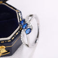 Three Blue Oval Stone Crisscross Ring In Polished Silver Tone view 3