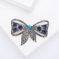 Crystal Bow Brooch in Metal with Crystal-covered Loops and a Colored Center Stone view 3