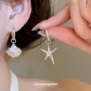 Silver Tone Starfish And Shell Huggie Earrings With Polished Metal Details