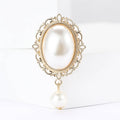 Oval Pearl Drop Brooch with Polished Metal and Decorative Accents view 1