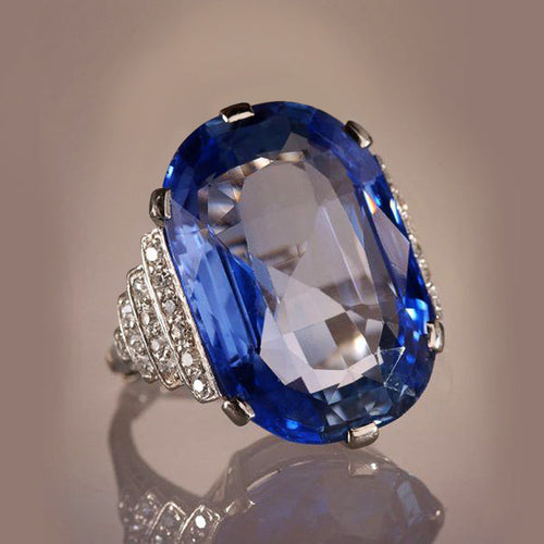 Product view showing silver-tone oversized deep-blue oval solitaire statement ring