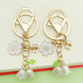 Bee and Honeycomb Charm Keychains Featuring White Blossom Across 10 Pictured Variations view 1