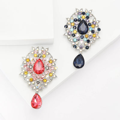 Jeweled Oval Brooch With Teardrop Dangle shown from the front on a white background