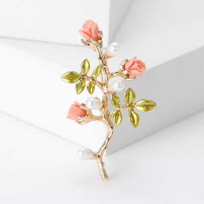 Front view of pink rose branch brooch with pearl and green leaves