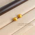 Matte Gold Tone Round Ball Stud Earrings In Five Graduated Sizes view 3