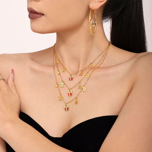 Layered gold gift box holiday necklaces on model side view
