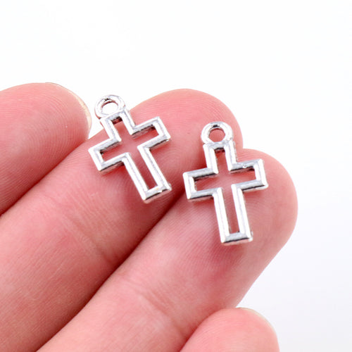 Finish comparison of openwork cross metal charms in gold bronze and silver tones