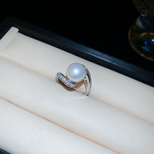 silver-tone open ring with a pearl-like orb and curved baguette crystal row shown in the first close product view