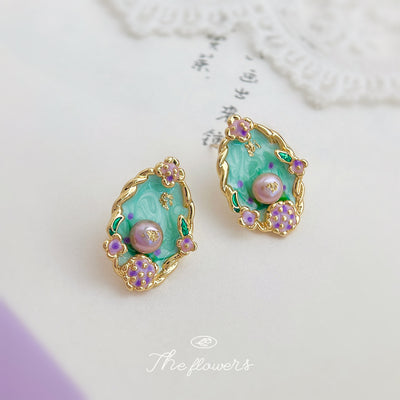 Mint green enamel pearl floral studs on white paper