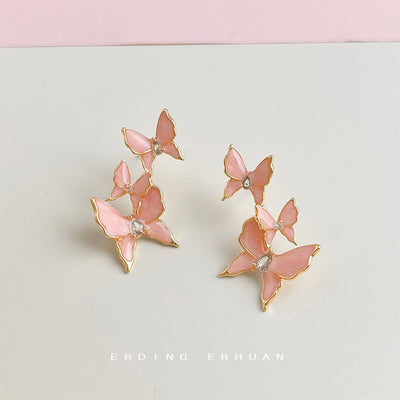 Gold-tone pink-butterfly cluster earrings showing the butterfly clusters.