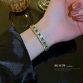Gold Tone Open Cuff Bracelet With Green And Clear Crystal Rows view 3