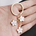 White Sakura Flower Enamel Charm Keychain with Gold Tone Ring view 3