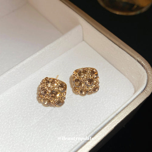 gold tone rounded square crystal cluster stud earrings displayed from a second angle