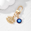 Gold Tone Open Lash Eye and Blue Evil Eye Clip Keychains view 3