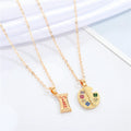 Gold Tone Artist Palette and Sweet Wrapper Pendant Necklaces view 1