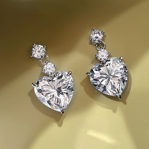 Clear white heart drop earrings silver tone on gold background