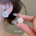 Ivory Resin Flower Stud Earrings With Gold Tone Centers view 2