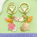 Flower Charm Keychains Featuring Pink Butterfly Across 10 Pictured Variations view 3