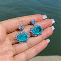 Aqua Blue Oval Halo Stone Drop Earrings in Silver Tone view 3