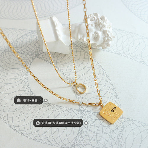 Gold layered necklace flat lay with length and plating labels